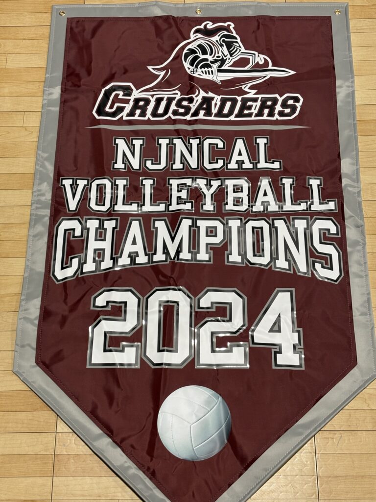 Photo of championship banner: CRUSADERS: NJNCAL VOLLEYBALL CHAMPIONS 2024