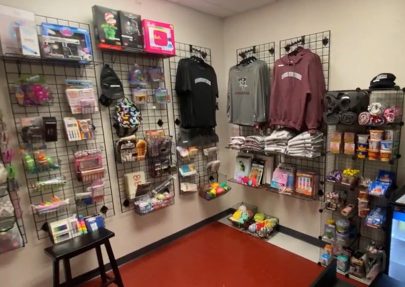 Inventory in school store - includes sweatshirts, snacks, fidgets, school supplies, plush items, games. 